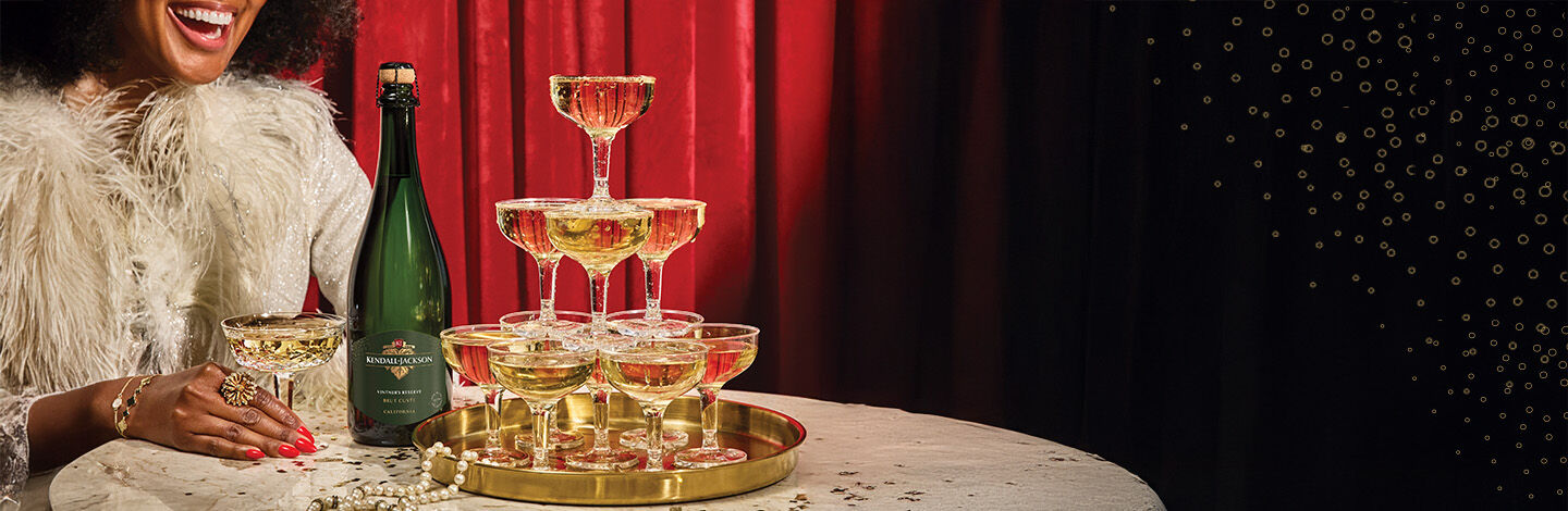 Close up of Kendall-Jackson branded corkscrew, cork and white wine in glasses.