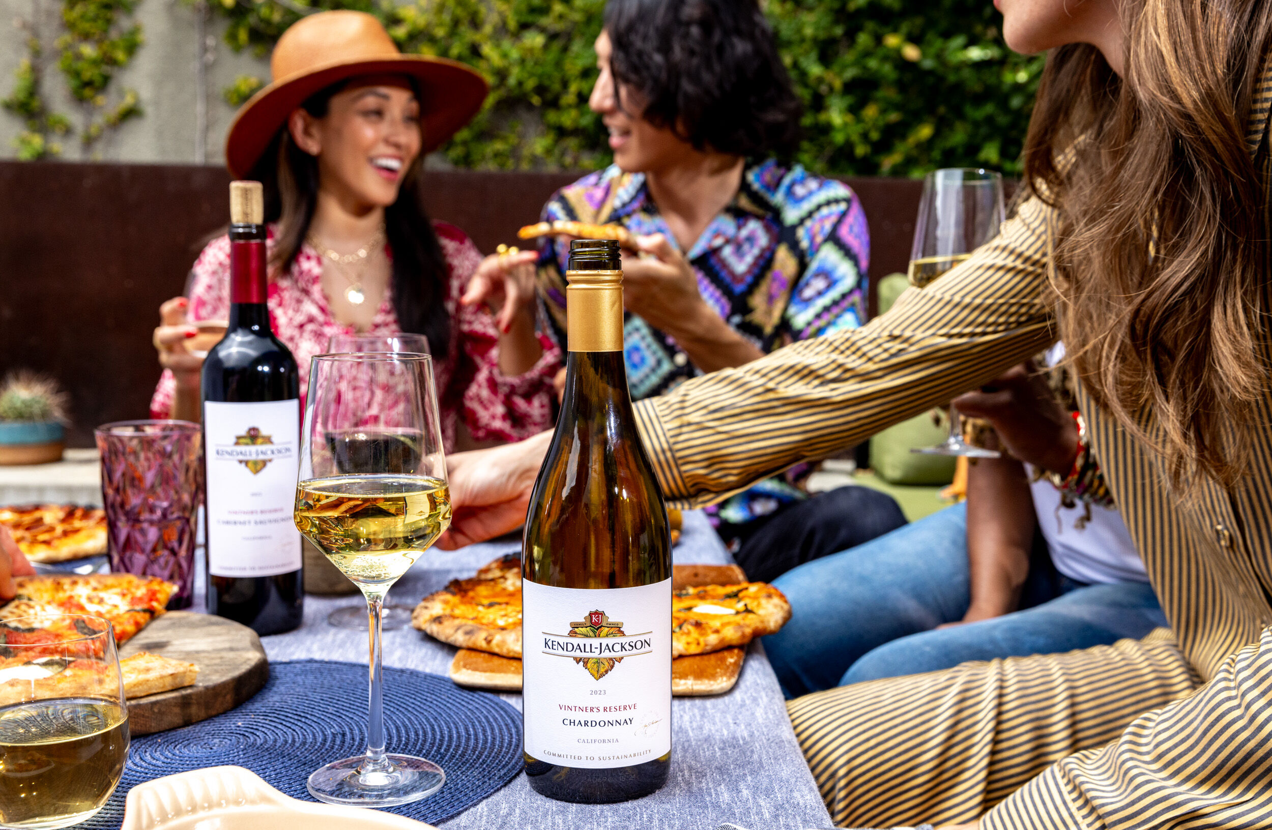 Friends enjoying pizza with Kendall-Jackson wine